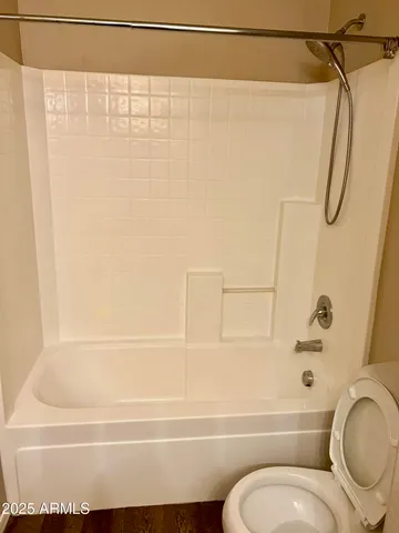 a bathroom with a shower a toilet and a sink