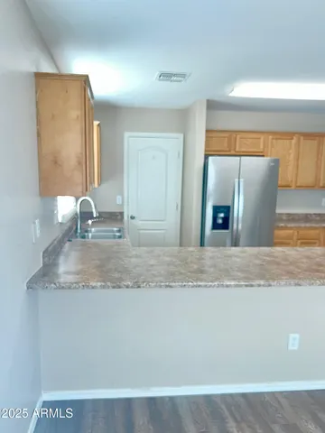 a view of a granite counter top a sink and dishwasher