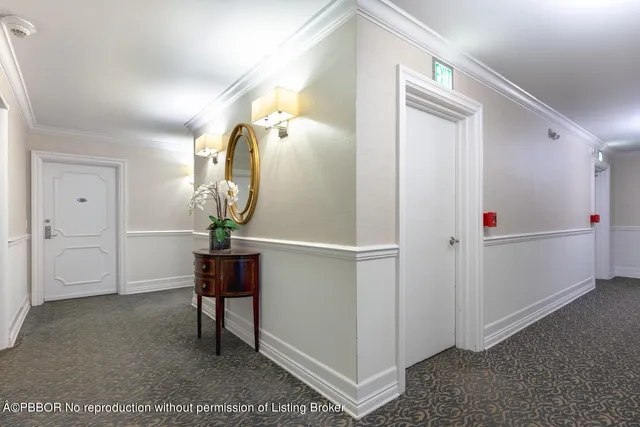 a view of a livingroom with wooden floor and bathroom