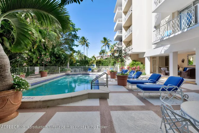 a view of a patio with swimming pool and sitting area