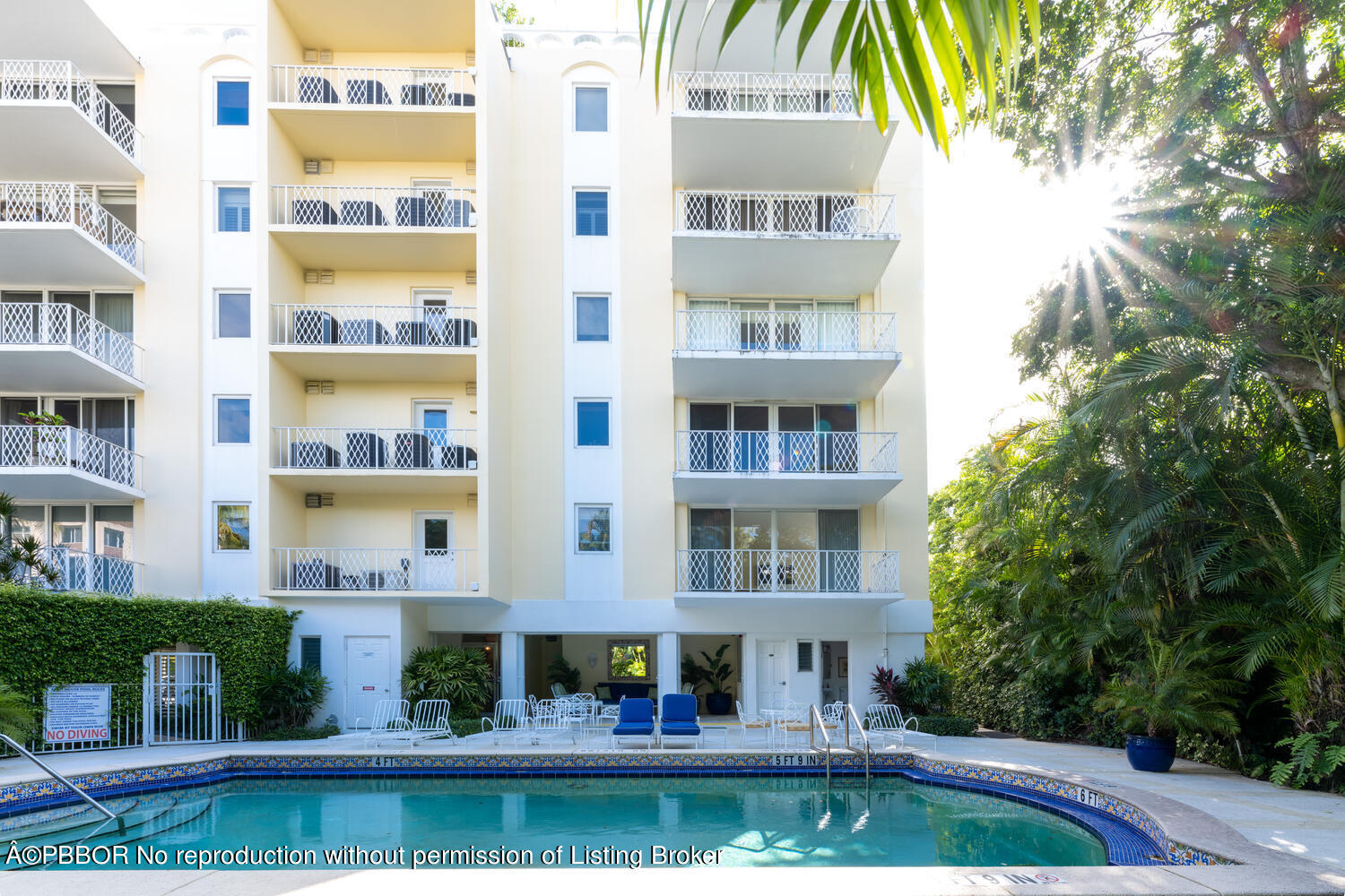 434 Chilean Avenue, Unit 2D Palm Beach, FL 33480 - Photo 18 of 19 a front view of a residential apartment building with a yard