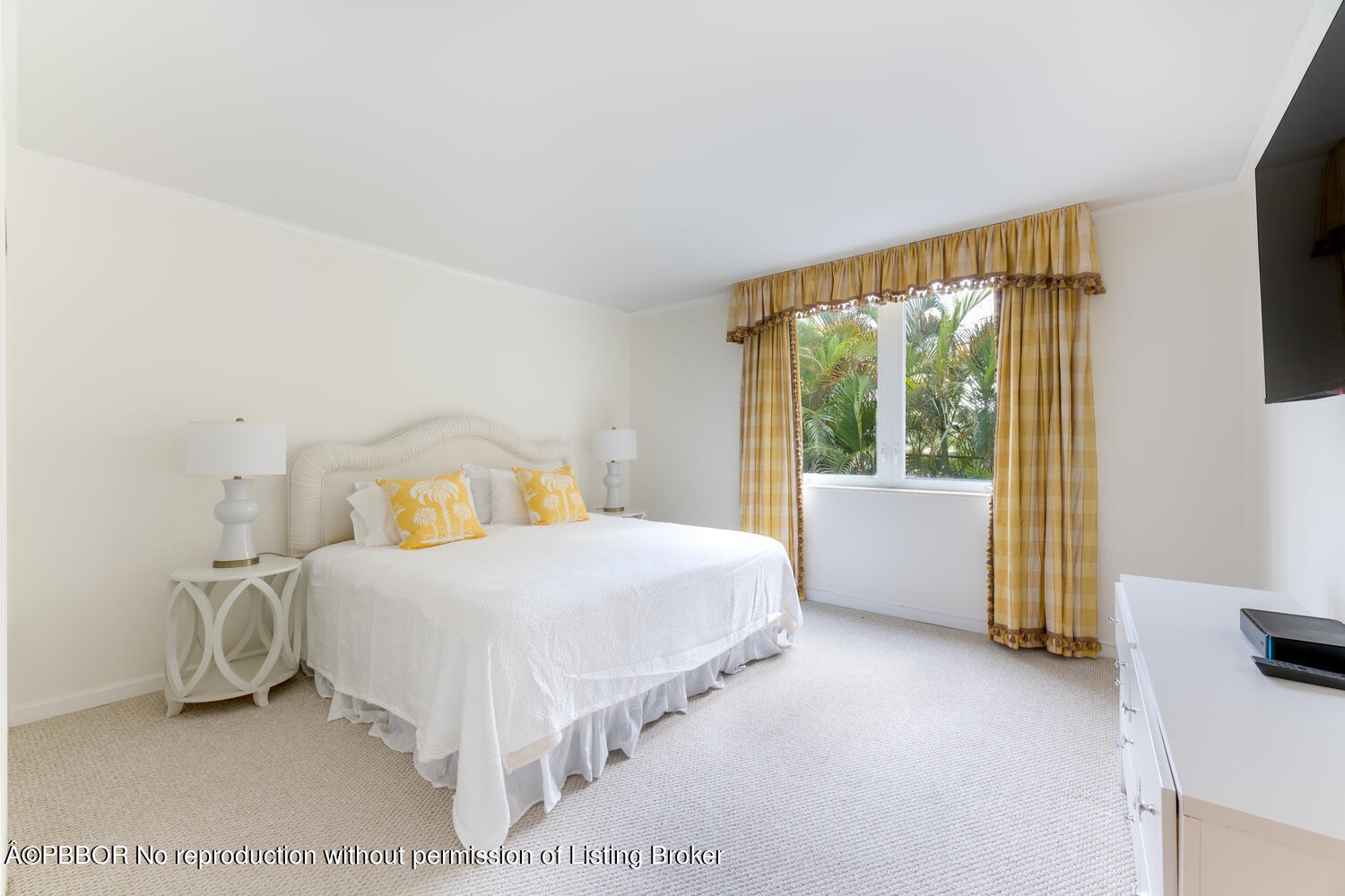 434 Chilean Avenue, Unit 2D Palm Beach, FL 33480 - Photo 8 of 19 a bedroom with a bed and a flat tv screen next to a window