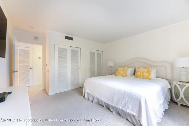 a bedroom with a bed and a cabinets