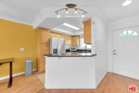 a kitchen with stainless steel appliances granite countertop a sink a stove and a refrigerator