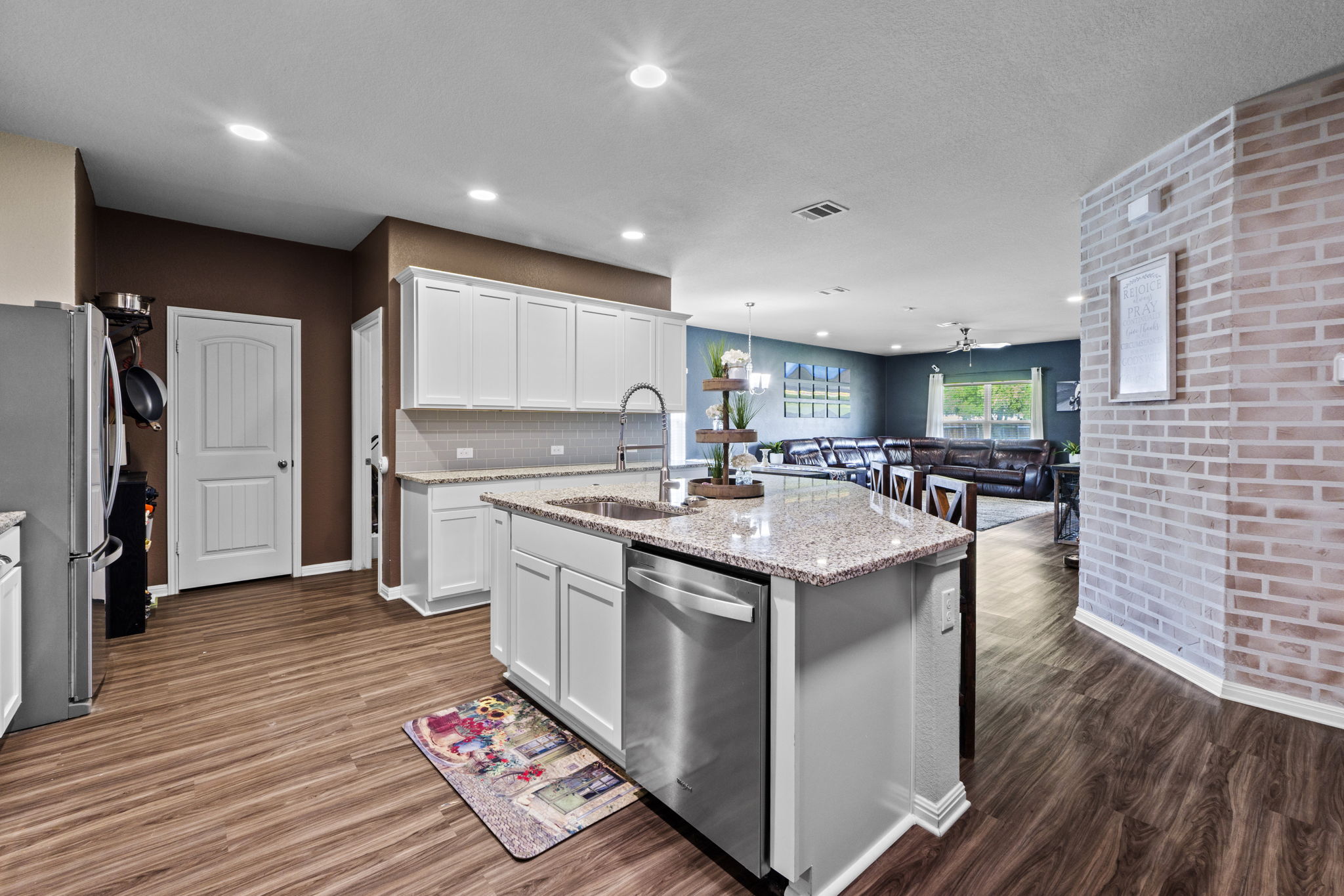 2417 Bridges Ranch Road Georgetown, TX 78628 - Photo 36 of 36 Kitchen with open floor plan, white cabinetry, stainless steel appliances, and a kitchen island with sink