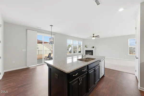 a kitchen with a stove a sink and a refrigerator