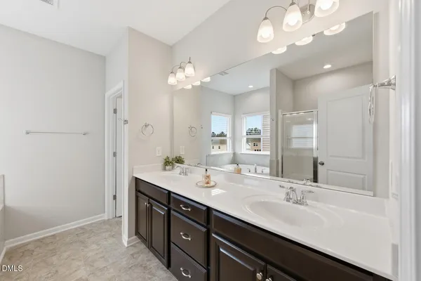 a bathroom with a double vanity sink and a mirror