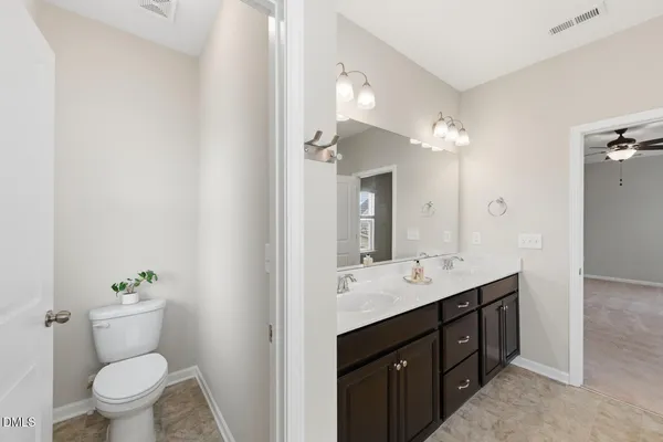 a view of bathroom with a sink toilet and a mirror