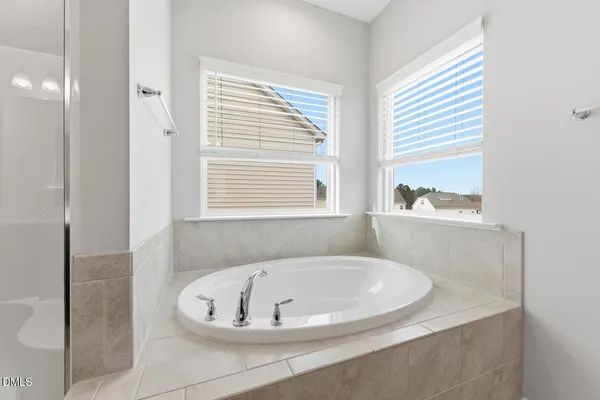 a white bath tub sitting next to a window