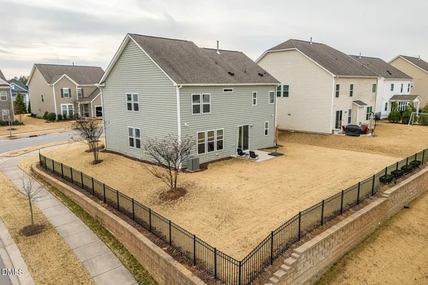 a view of a house with wooden fence