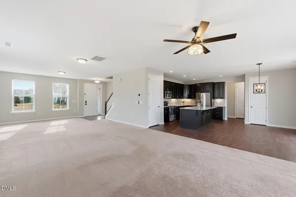 a view of a livingroom with a ceiling fan and window