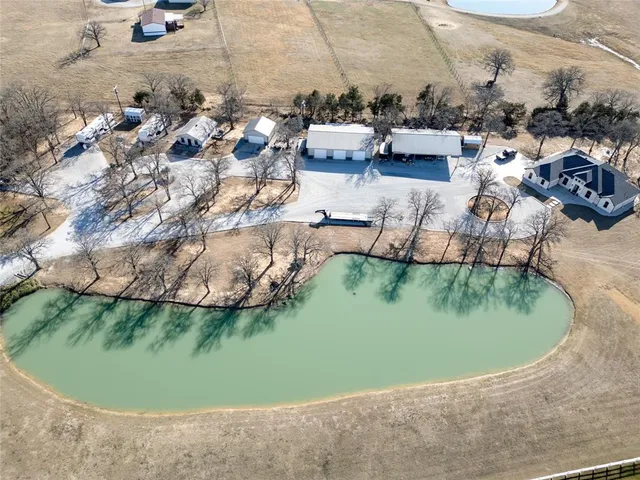 an aerial view of a house with a lake view