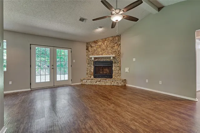 wooden floor chandelier and windows in a room
