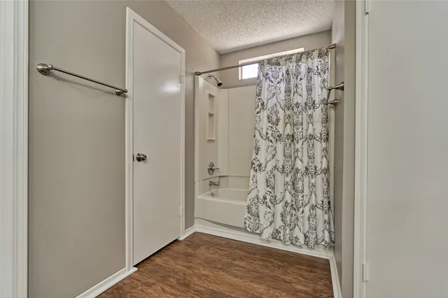 a view of bathroom with shower and a window