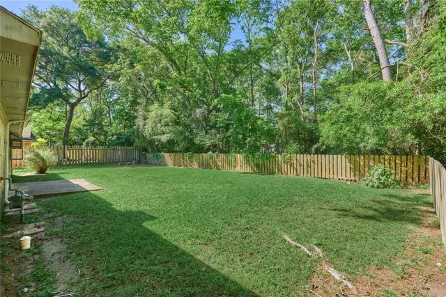 a view of backyard with deck and a garden
