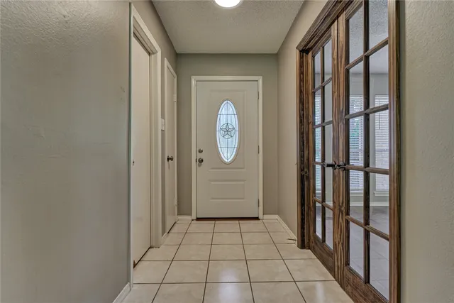 a view of a hallway with wooden door