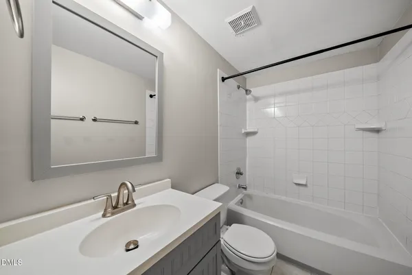 a bathroom with a sink mirror bathtub and toilet