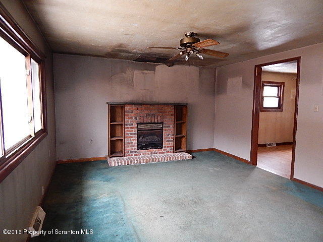 3 Rr Hop Bottom, PA 18824 - Photo 5 of 13 an empty room with windows and fireplace