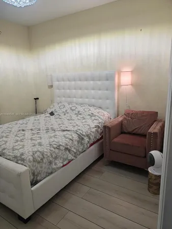 a bedroom with a bed and a couch