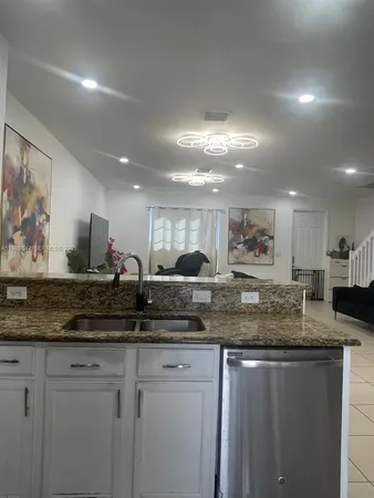 a kitchen with stainless steel appliances granite countertop a sink and cabinets