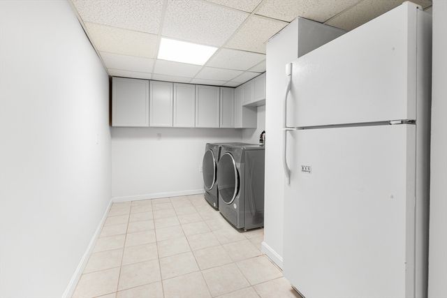 a view of a kitchen with a sink and a refrigerator