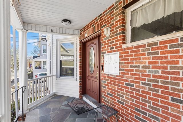 a view of a brick house with a door and wooden floor