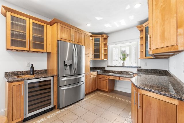 a kitchen with stainless steel appliances granite countertop a stove and a refrigerator