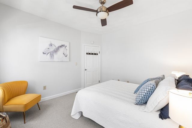 a bedroom with a bed and chair