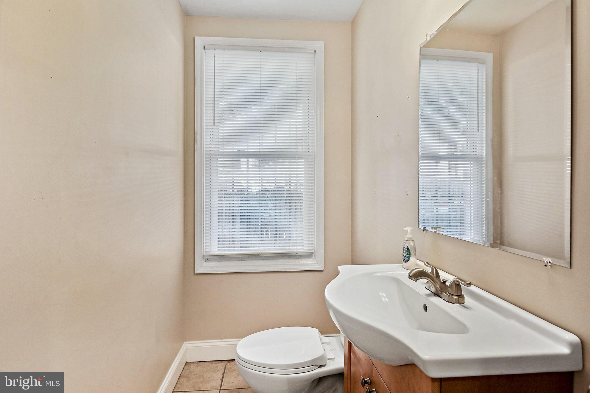 211 North Streeper Street Baltimore, MD 21224 - Photo 13 of 33 a bathroom with a sink and a toilet