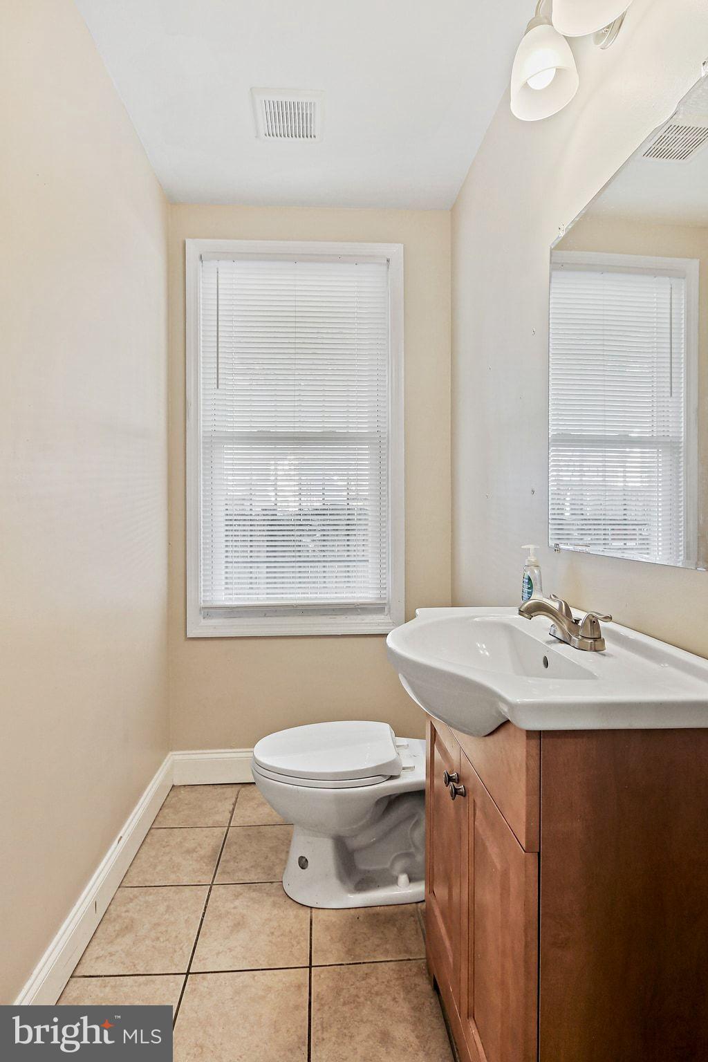 211 North Streeper Street Baltimore, MD 21224 - Photo 14 of 33 a bathroom with a sink toilet and mirror