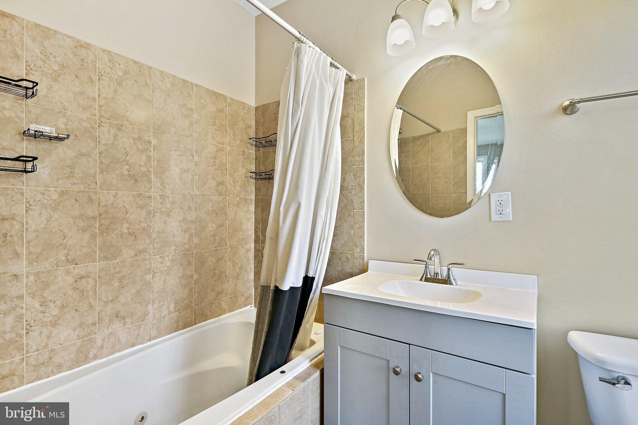 211 North Streeper Street Baltimore, MD 21224 - Photo 18 of 33 a bathroom with a sink and a mirror