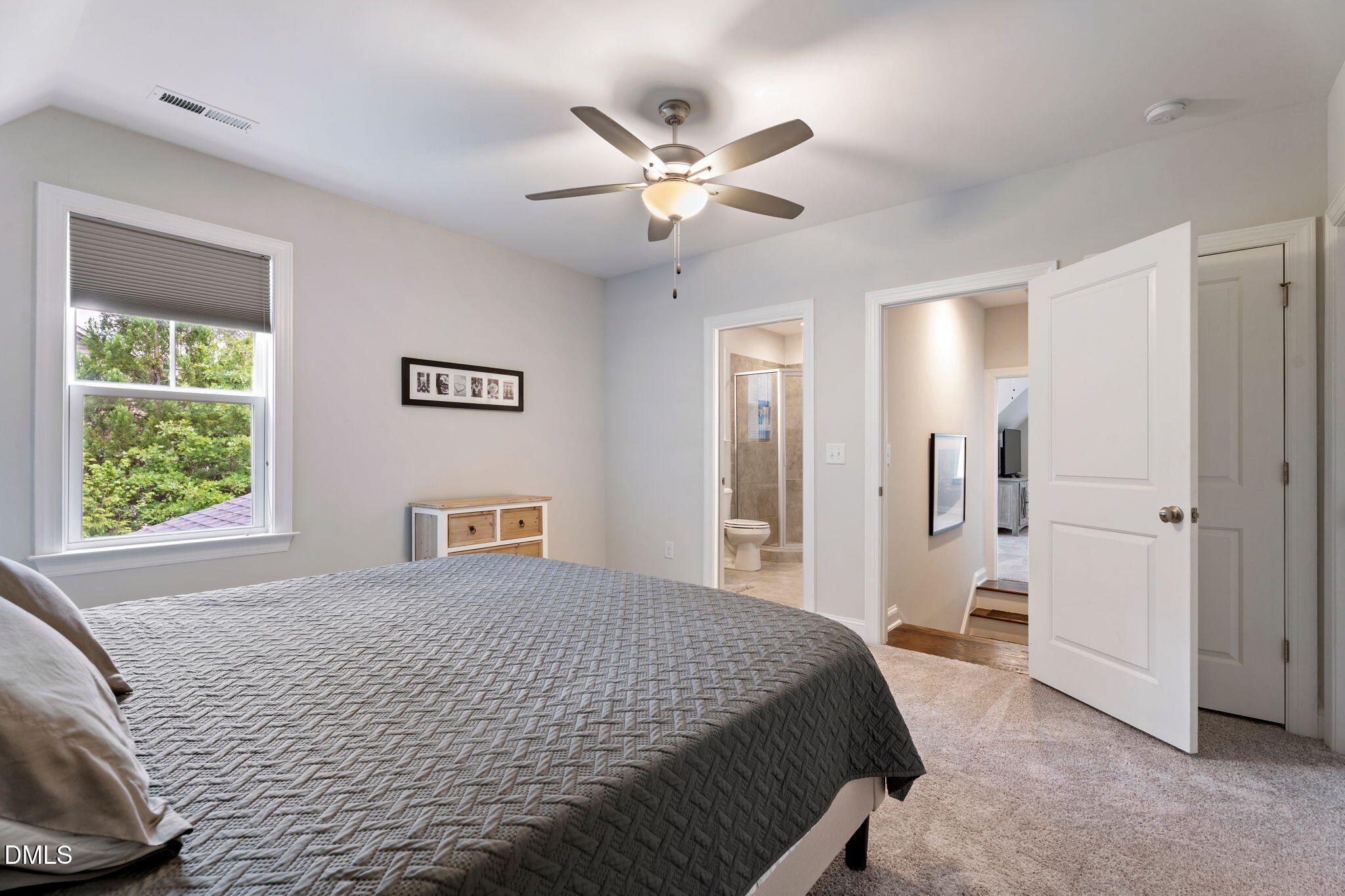 223 Colonial Ridge Drive Pittsboro, NC 27312 - Photo 29 of 47 a bedroom with a large bed and a chandelier