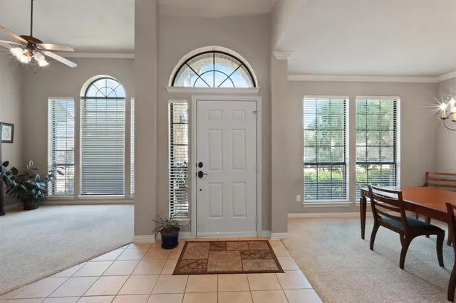 a dining room with furniture a chandelier and window