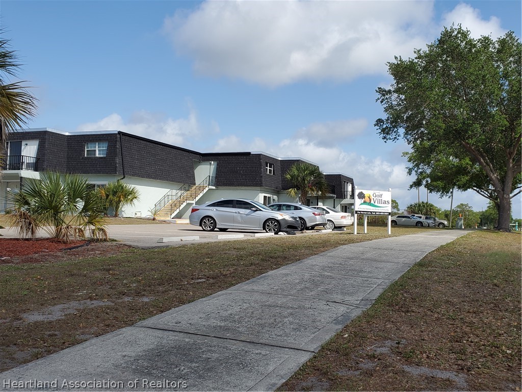 105 Golf Villas Court Northwest Lake Placid, FL 33852 - Photo 1 of 13 a couple of cars parked in front of a building