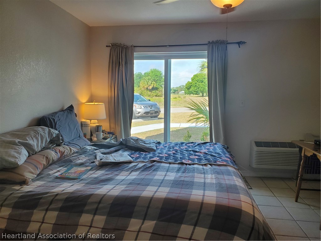 105 Golf Villas Court Northwest Lake Placid, FL 33852 - Photo 5 of 13 a bedroom with a bed and next to a window