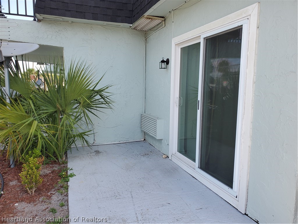 105 Golf Villas Court Northwest Lake Placid, FL 33852 - Photo 9 of 13 a view of a potted plant in front of a door