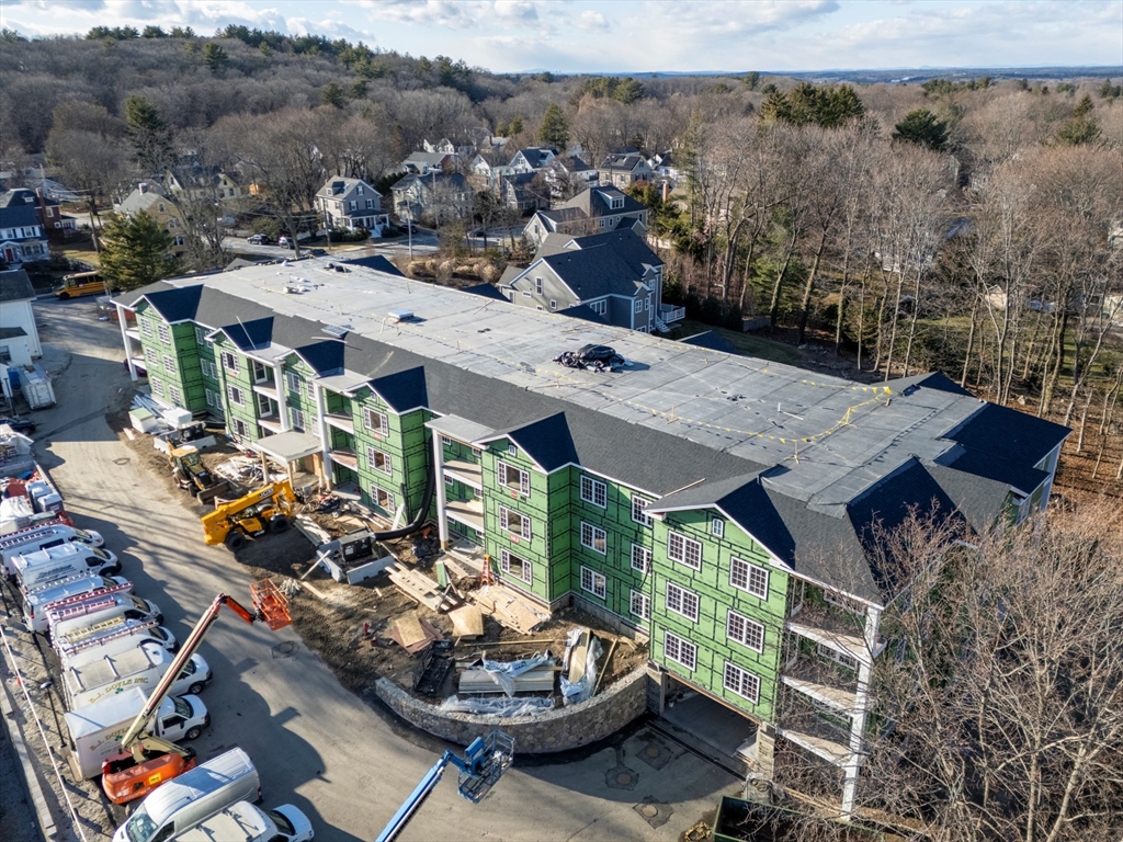 93 Bedford Street, Unit 201 Lexington, MA 02420 - Photo 6 of 7 an aerial view of a house with a patio and a fountain