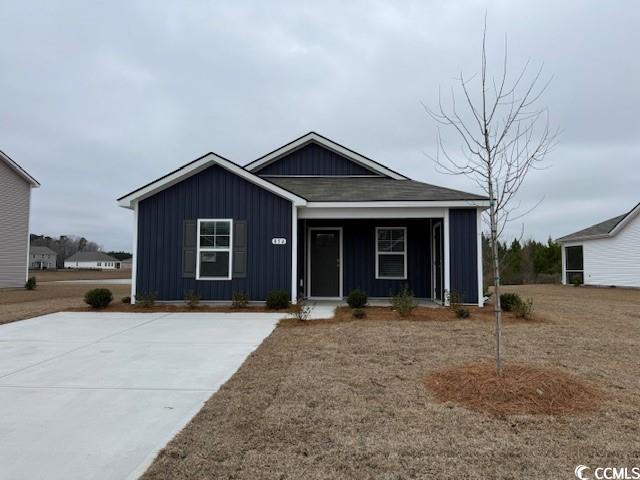 View of front of home featuring a porch and roof with shingles