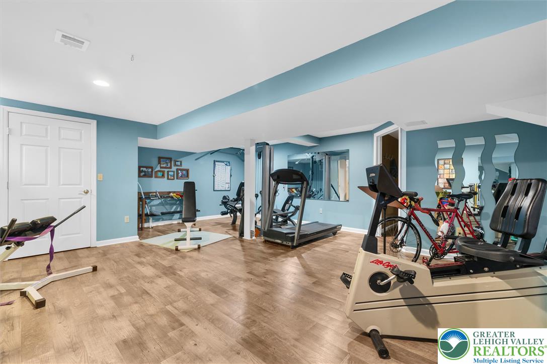 5616 Snowdrift Road Orefield, PA 18069 - Photo 27 of 36 Discover a dedicated workout zone with resilient flooring for all your fitness endeavors.