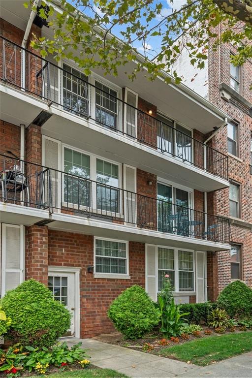 101-06 4th Avenue, Unit 26E Brooklyn, NY 11209 - Photo 1 of 16 a front view of a building with a garden
