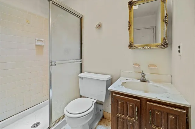 a bathroom with a granite countertop toilet a sink and a bathtub