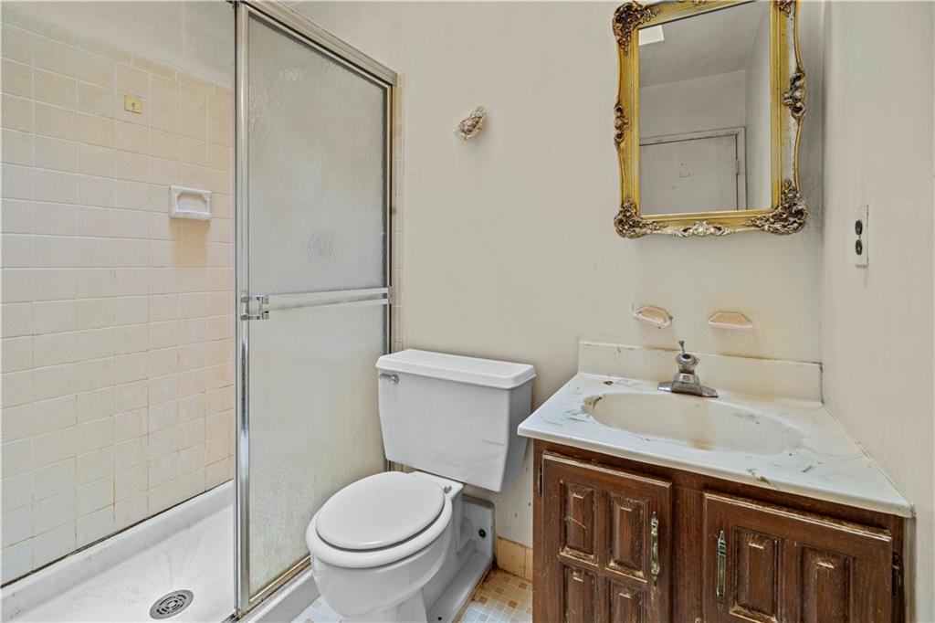 101-06 4th Avenue, Unit 26E Brooklyn, NY 11209 - Photo 12 of 16 a bathroom with a sink a toilet and a mirror