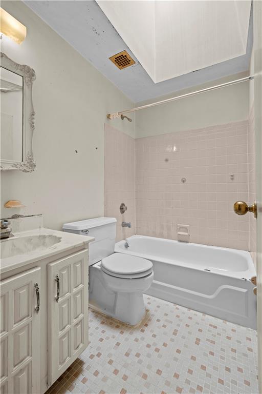 101-06 4th Avenue, Unit 26E Brooklyn, NY 11209 - Photo 13 of 16 a bathroom with a granite countertop toilet a sink and a bathtub