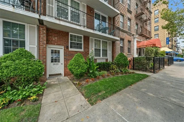 a front view of a house with car parked