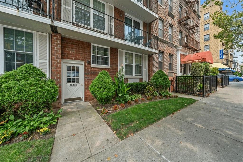 101-06 4th Avenue, Unit 26E Brooklyn, NY 11209 - Photo 14 of 16 front view of a brick house with a yard