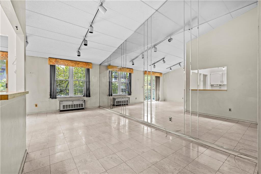 101-06 4th Avenue, Unit 26E Brooklyn, NY 11209 - Photo 4 of 16 a view of an empty room with a window
