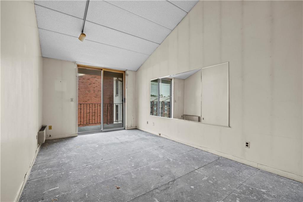 101-06 4th Avenue, Unit 26E Brooklyn, NY 11209 - Photo 9 of 16 an empty room with windows