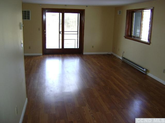 25 Helsley Road Germantown, NY 12526 - Photo 3 of 7 an empty room with wooden floor and windows