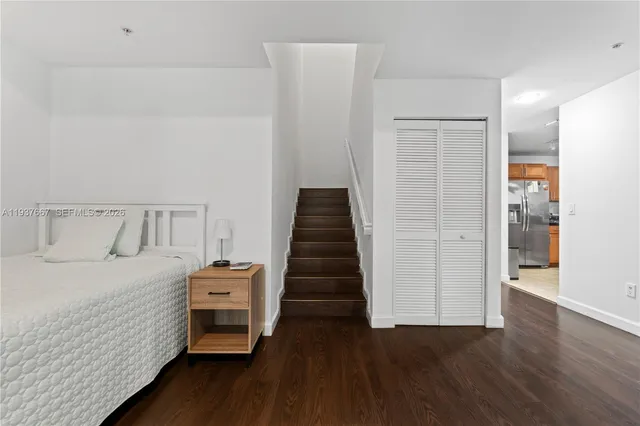 a bedroom with a bed and wooden floor