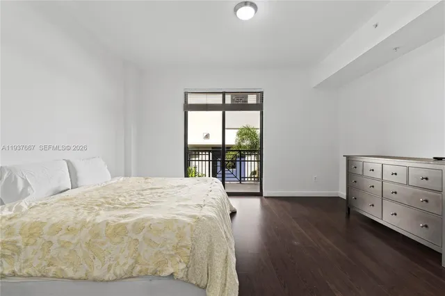 a spacious bedroom with a bed and a window